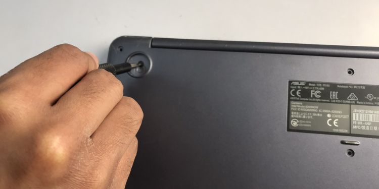 unscrew each screw under rubber feet