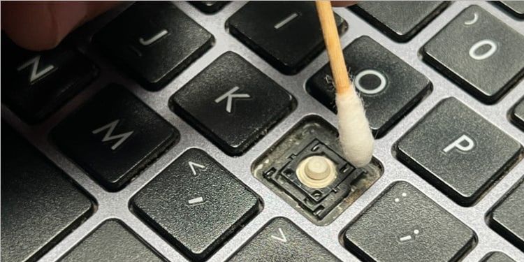 clean key hinges using cotton bud
