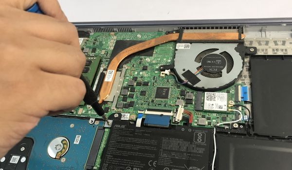 untighten screws that hold hard drive caddy in place