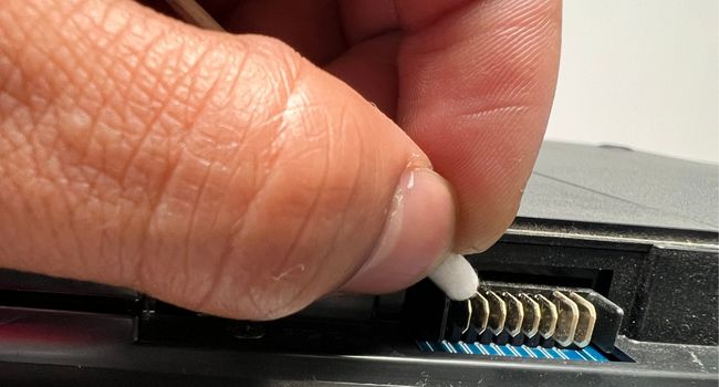 clean external laptop battery pins