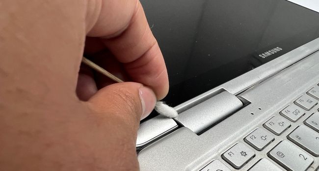 extend laptop to clean the hinge