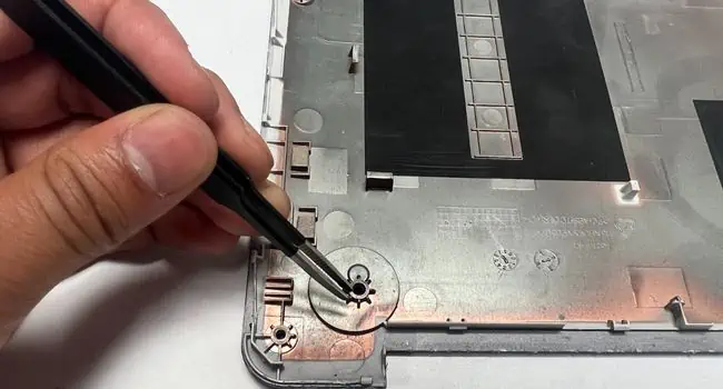 How to Clean a Laptop: Comprehensive Guide 66 pluck-out-hair-using-tweezers-inner-section-of-bottom-casing