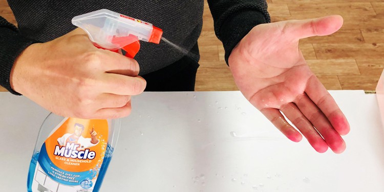 spray-glass-cleaner-into-hands