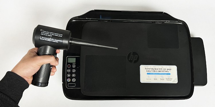 use-blower-to-blow-exterior-of-printer