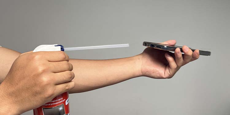spraying compressed air in charging port
