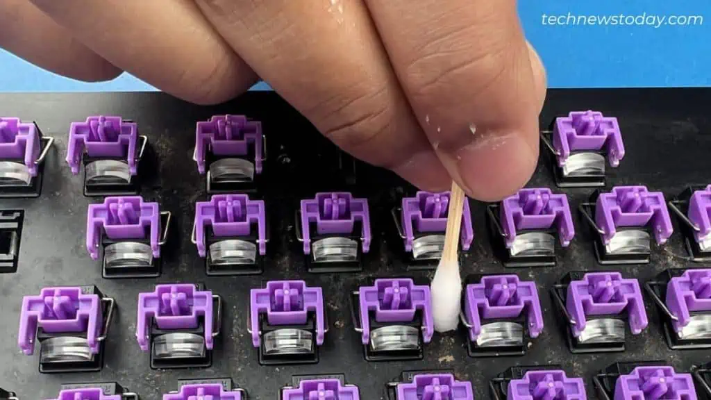 cleaning-between-keys-using-cotton-swab-1024x576
